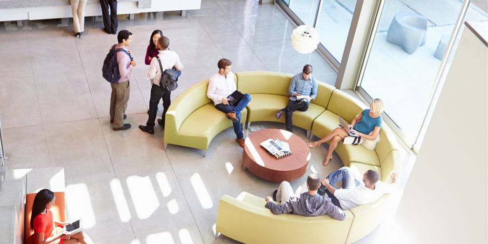 Reception area of modern office building with people