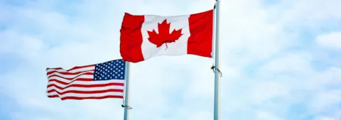 American and Canadian flags